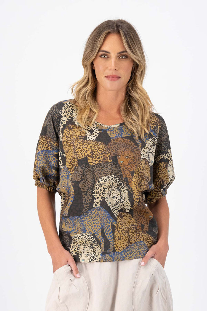 Olga de Polga Camisa blouse in Sabana printed fine Tencel. Reversible top with a soft v-neck on one side and a boatneck on the other. Half sleeves. Tapers in at the waist. Front view on model.