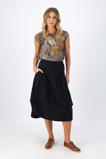 Olga de Polga Milwaukee Fiesta skirt in Black 100% Slubbed linen. Large patch pockets. Elasticated waistband. Front view on model