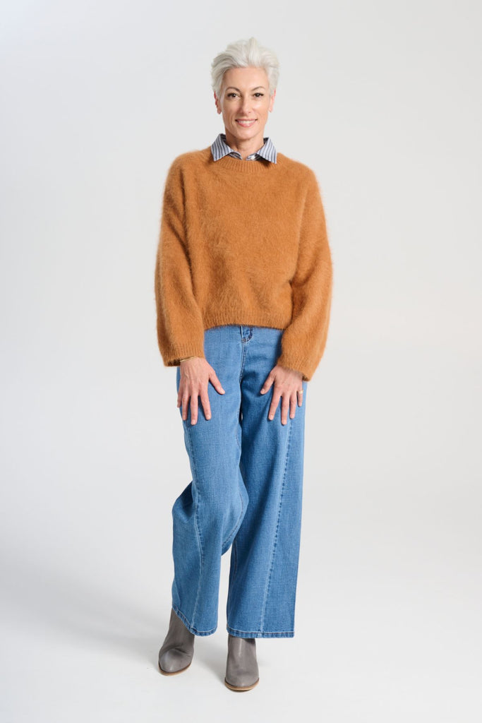 Olga de Polga angora Montreal knit sweater in Caramel brown. he knit features a ribbed round neckline, drop shoulder and cropped length, so it is perfect with jeans and skirts. The fit is slightly oversized with a boxy cut and long sleeves. Front full length view on model