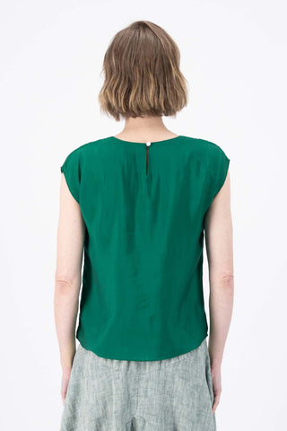 Olga de Polga dark green Skyscraper tee in 100% tencel with a slight sheen. Crew neckline, cap sleeves, and finishes at the hip. Back close-up view on model.