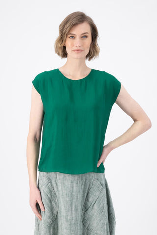 Olga de Polga dark green Skyscraper tee in 100% tencel with a slight sheen. Crew neckline, cap sleeves, and finishes at the hip. Front view on model.