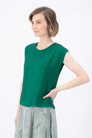 Olga de Polga dark green Skyscraper tee in 100% tencel with a slight sheen. Crew neckline, cap sleeves, and finishes at the hip. Side close-up view on model.