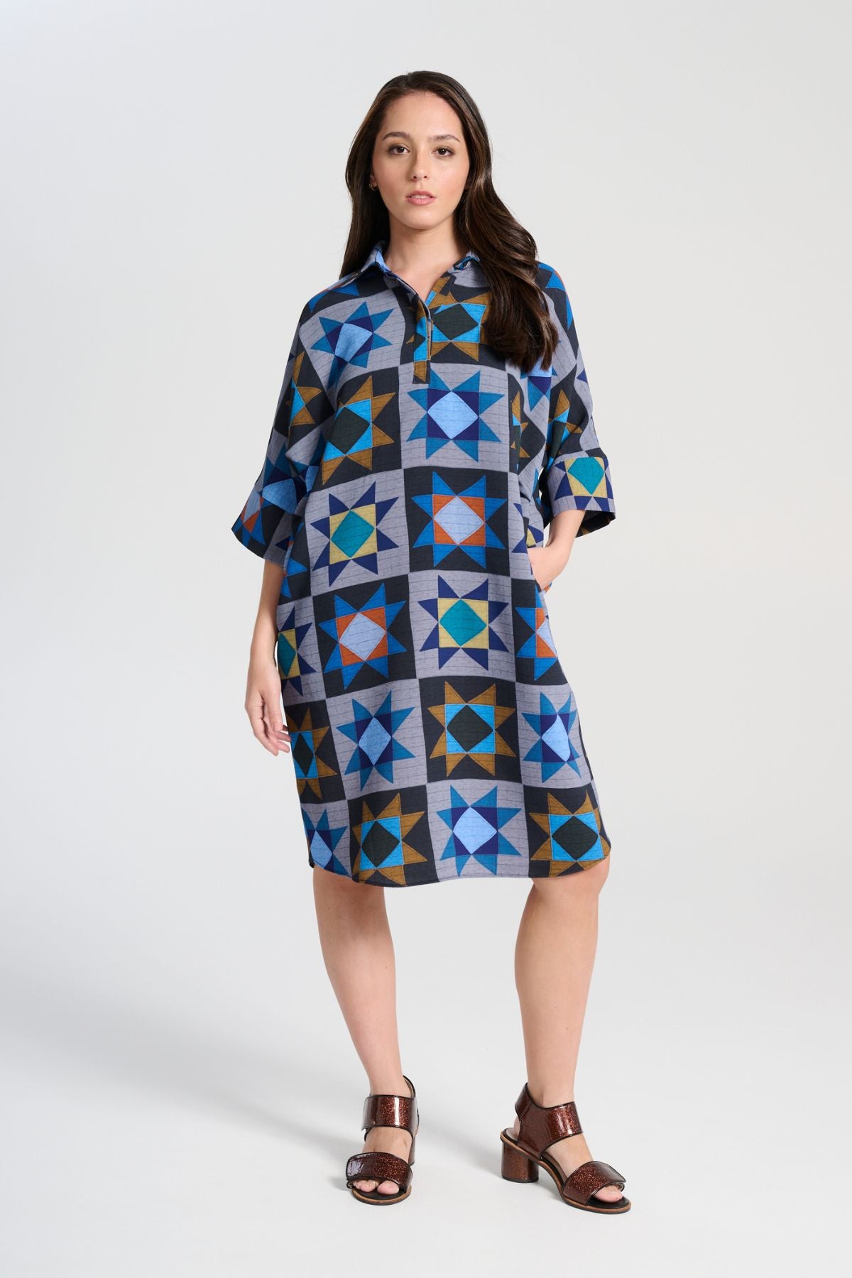 Olga de Polga Estilo dress in Veda Night printed heavy crepe. Shift dress with a collar and button front at the neck. Half sleeves. Finishes at the knee depending on height. Front view on model.