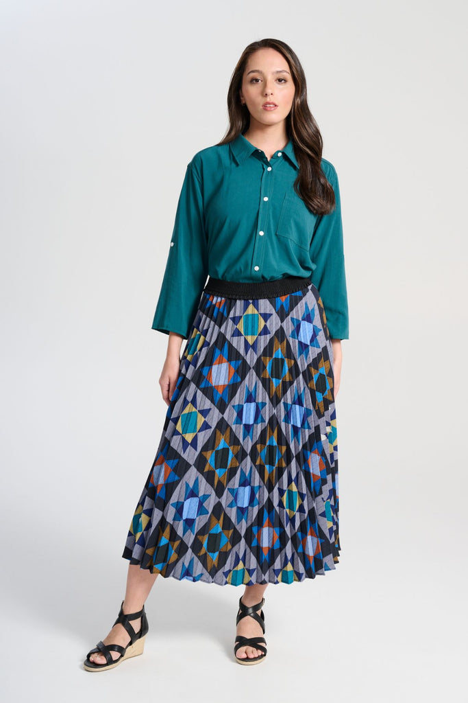 Olga de Polga Pleated Veda Night skirt in printed recycled polyester. Our pleated skirts are comfortable and functional enough to wear for every occasion, with the pleats creating beautiful movement with each step, with a fully elasticated waistband. Front view on model