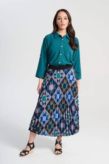 Olga de Polga Pleated Veda Night skirt in printed recycled polyester. Our pleated skirts are comfortable and functional enough to wear for every occasion, with the pleats creating beautiful movement with each step, with a fully elasticated waistband. Front view on model