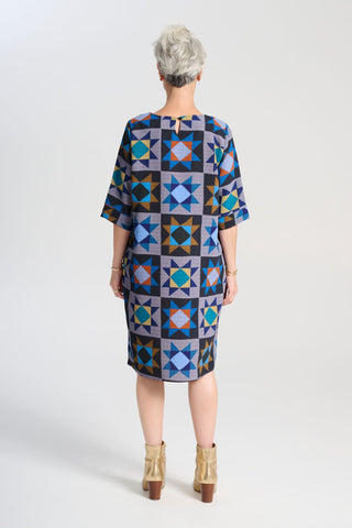 Olga de Polga Sencillo dress in Veda Night printed heavy crepe. Shift dress with half sleeves and a round neckline. Finishes at the knee depending on height. Back view on model