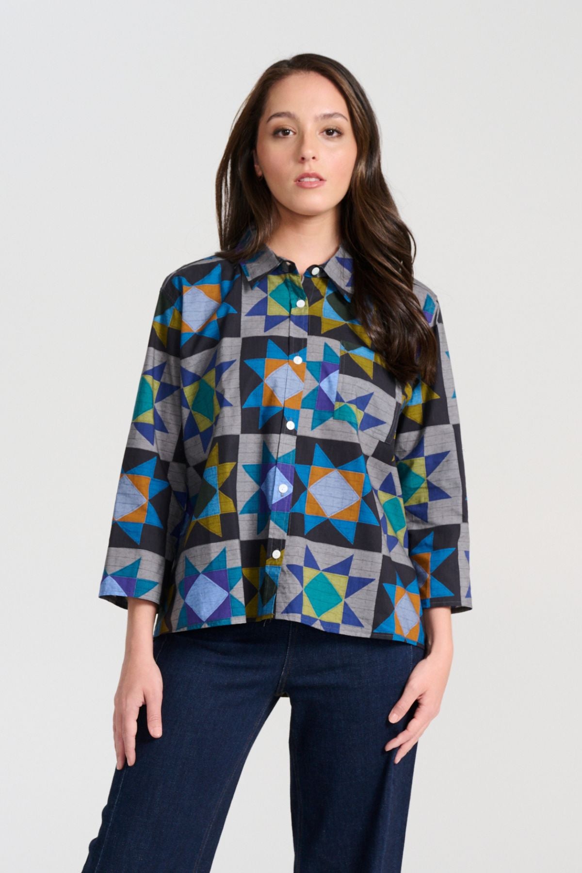 Olga de Polga Veda Shirt in Night printed cotton. Front view on model. It has an effortlessly chic, relaxed silhouette that drapes with ease. Leave it loose or tuck it in - the choice is yours.
The front of the shirt sits at the waist while the back falls to the hips for a lovely drape. Front view on model