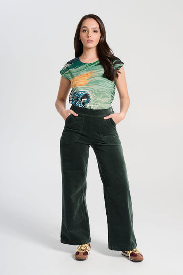 Olga de Polga best selling Forest Green Peggy Paris pants in soft velvet, long length. Comfy high waist, large pockets, side zip. Elastic back waist. Front view on model.