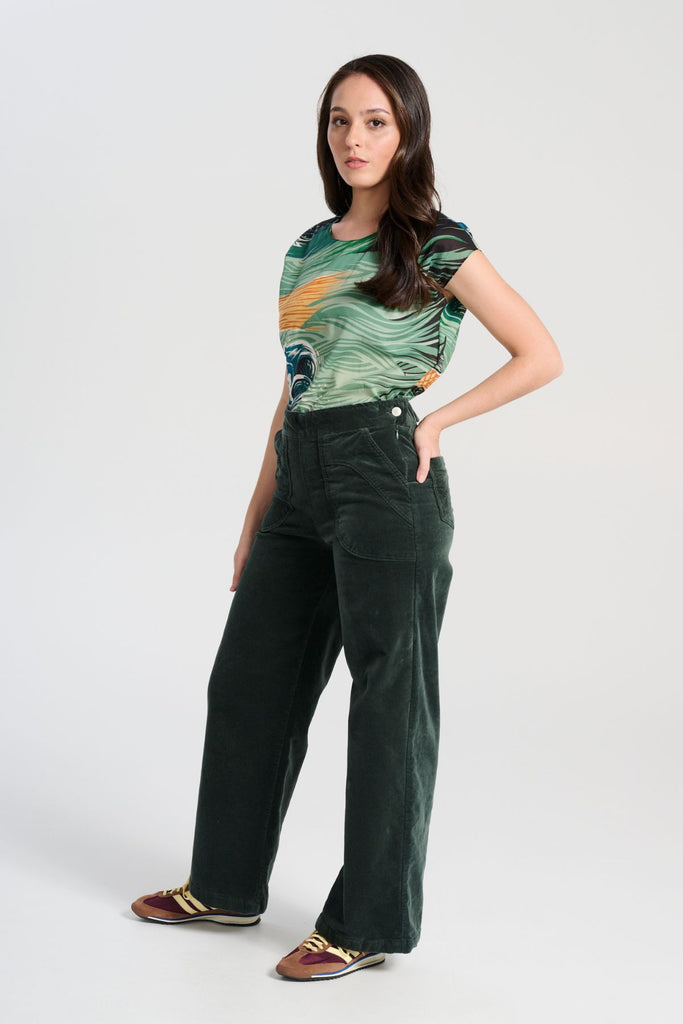 Olga de Polga best selling Forest Green Peggy Paris pants in soft velvet, long length. Comfy high waist, large pockets, side zip. Elastic back waist. Side view on model