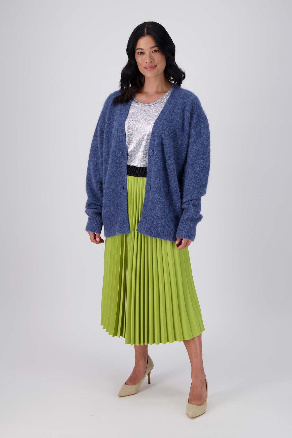 Olga de Polga pleated skirt. Get the best of both worlds with the Chameleon Pleated Skirt. Featuring a two-toned colour-block, separated along the side seams creating a contrasted front and back. Available in three colour combinations; green and blue, grey and black, and blush and chocolate. Front view on model