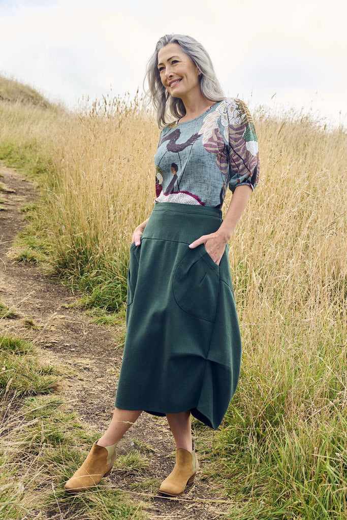 Olga de Polga Milwaukee Foundry Skirt in Bottle Green. 100% Cotton. Unique A-line panelled design. Elastic waistband at the back.  Side front view on model