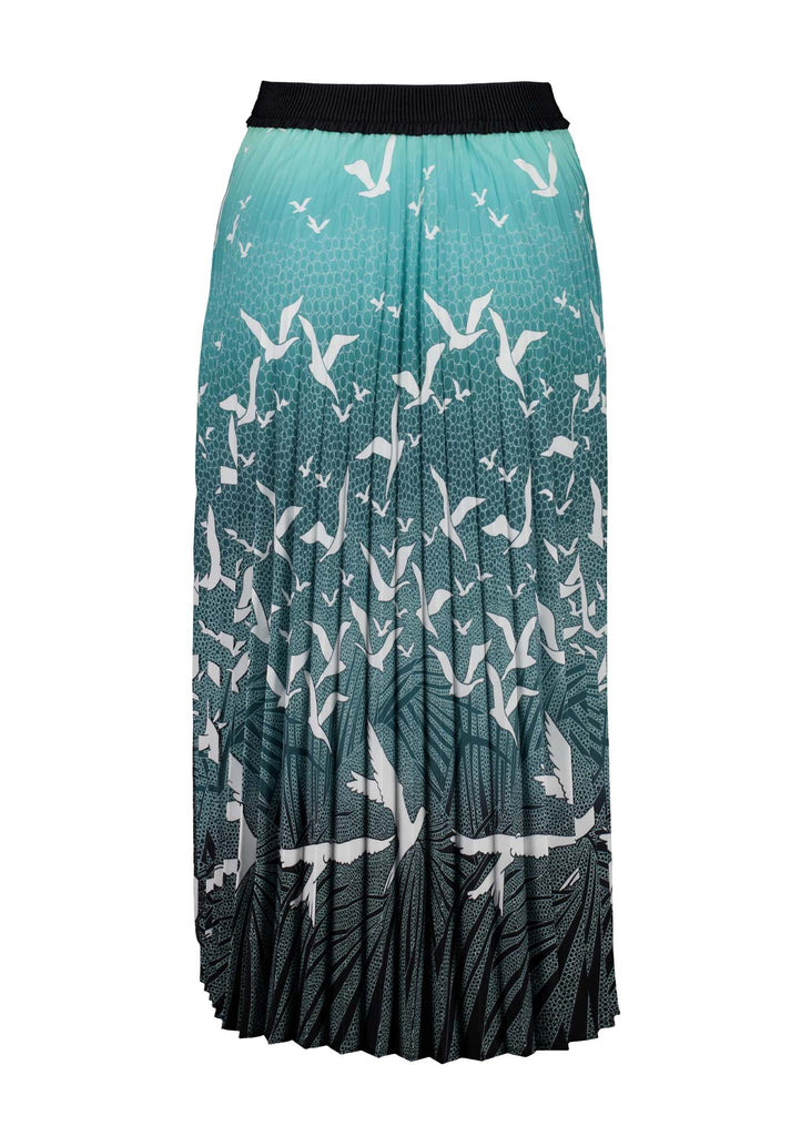 Olga de Polga pleated skirt in our new print, Homebound Green. Dive into the graceful movement of "Homebound," where the enchanting dance of a flock of birds takes centre stage. Capturing the spirit of returning to the heart of home, this print symbolises a journey, a reunion, and the comforting embrace of familiar skies. Back