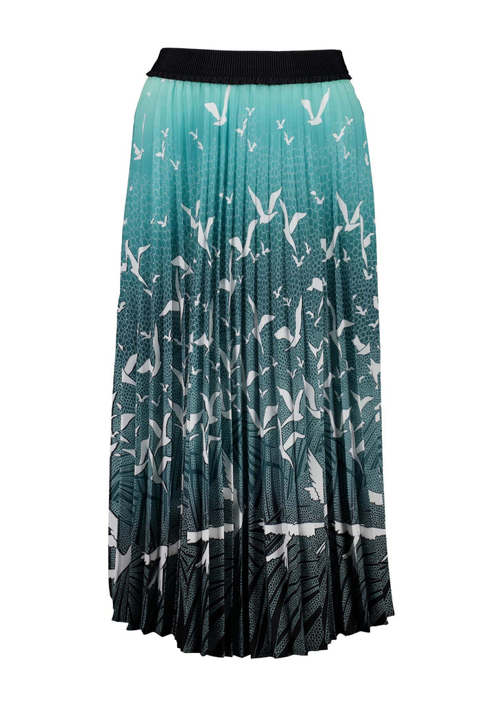 Olga de Polga pleated skirt in our new print, Homebound Green. Dive into the graceful movement of "Homebound," where the enchanting dance of a flock of birds takes centre stage. Capturing the spirit of returning to the heart of home, this print symbolises a journey, a reunion, and the comforting embrace of familiar skies. Front