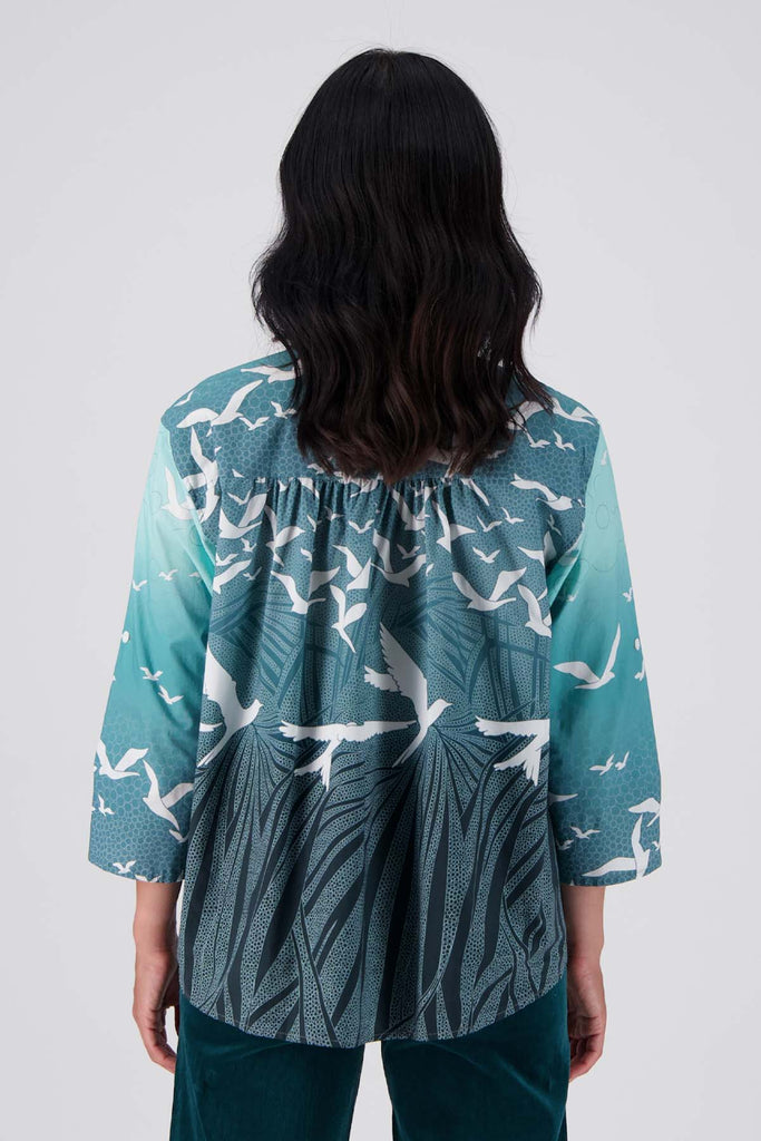 Olga de Polga classic shirt in our new Green Homebound printed cotton. The front of the shirt sits at the waist while the back falls to the hips for a lovely drape. Perfect for leaving loose over pants or for tucking into any bottoms. Back view on model