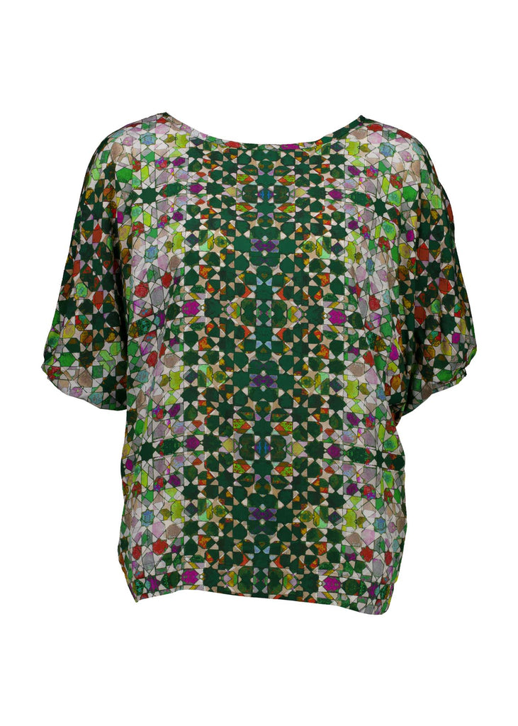 Olga de Polga Kaleidoscope Green Camisa Blouse in printed fine Tencel. This is a reversible top with the choice of a soft V-neck and a boat neck which are interchangeable. Half length sleeves. Finishes at the hip. Front reversible top, close up view.