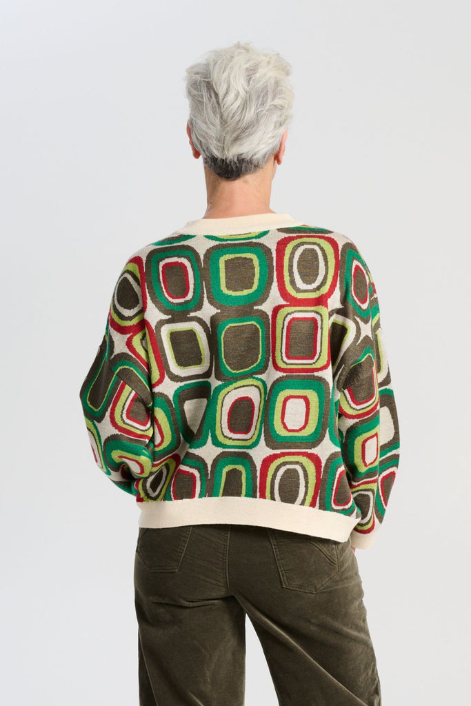 Olga de Polga retro patterned knit Bristol Lush green sweater in a soft merino wool blend. Long sleeves, and round neckline. Back view on model