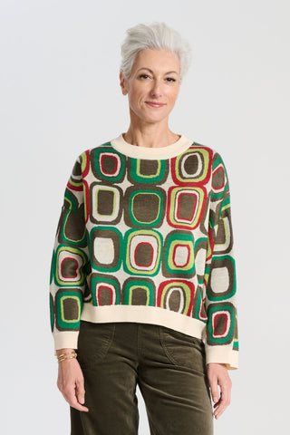Olga de Polga retro patterned knit Bristol Lush green sweater in a soft merino wool blend. Long sleeves, and round neckline. Front view on model