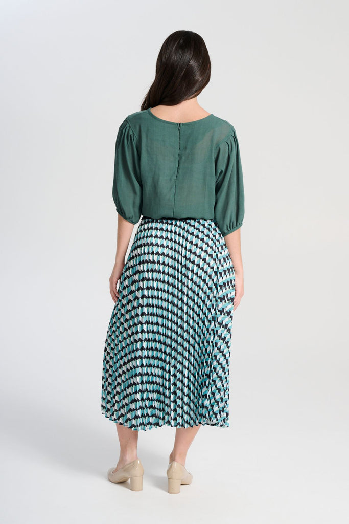 Olga de Polga Green/Blue Seraph pleated skirt in Marine. Printed geometric design. Fully elasticated waistband, very comfy. Midi length. Back view on model