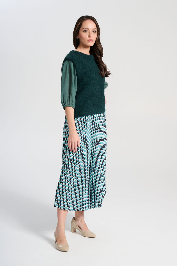 Olga de Polga Green/Blue Seraph pleated skirt in Marine. Printed geometric design. Fully elasticated waistband, very comfy. Midi length.  Side view on model