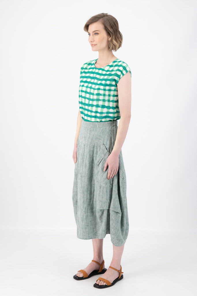 Olga de Polga Milwaukee Panorama woven skirt in Green. Our Milwaukee Skirt is an incredibly unique, chic and original skirt. It is universally flattering, highly versatile, and super comfortable. Perfect to throw on and go. Side view on model.