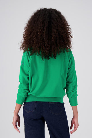 Olga de Polga Green Montage sweatshirt in a cotton tence blend. The sweatshirt has abstract embroidered motifs. Ribbing at the neckline, cuffs and hem add durability to the sweatshirt. Back view on model