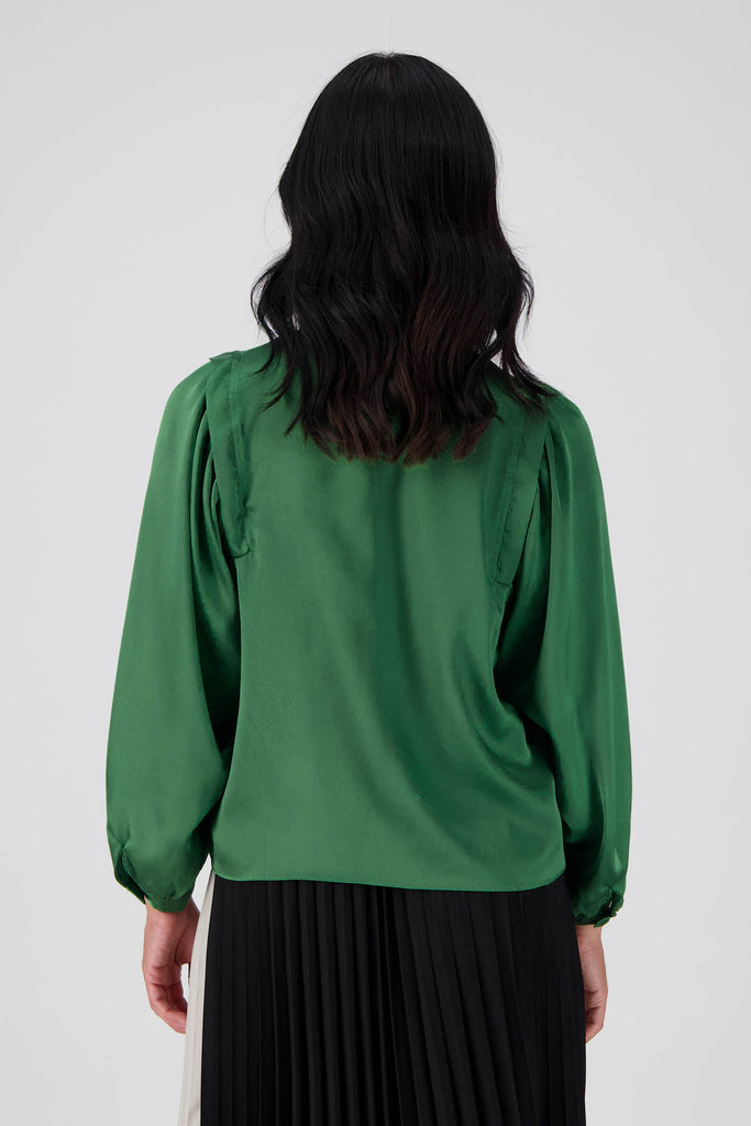 Olga de Polga Green Moonshine Blouse in satin. Billowing sleeves and a round neck make this the perfect blouse to dress up or down for any occasion. Back view on model