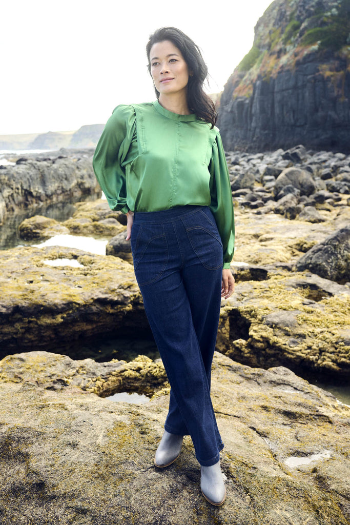 Olga de Polga Green Moonshine Blouse in satin. Billowing sleeves and a round neck make this the perfect blouse to dress up or down for any occasion. Front view on model