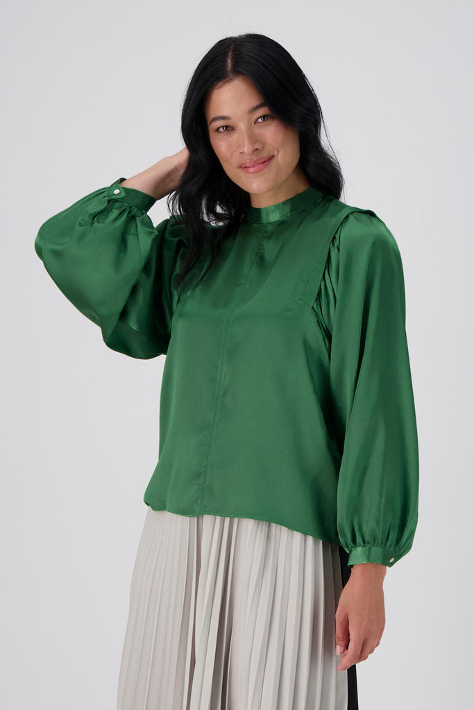 Olga de Polga Green Moonshine Blouse in satin. Billowing sleeves and a round neck make this the perfect blouse to dress up or down for any occasion. Front close up view