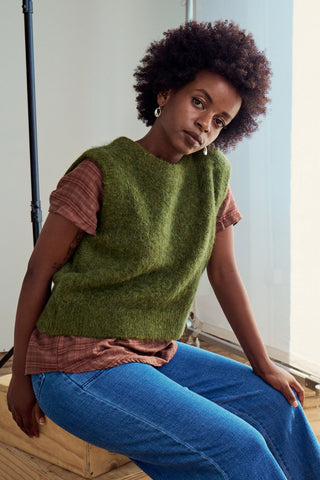 Olga de Polga Apsen Knit Vest in Moss Green alpaca. Front close-up view on model. Ribbing at neckline and hemline Sleeveless design for easy layering.  Front close-up view on model.