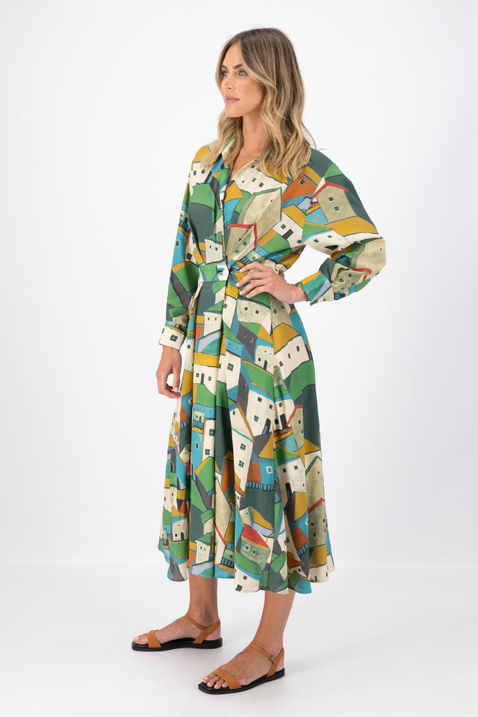 Olga de Polga Green Pueblito parisian wrap dress in 100% viscose with long sleeves and an elasticated back waist. Midi length. Side view on model.