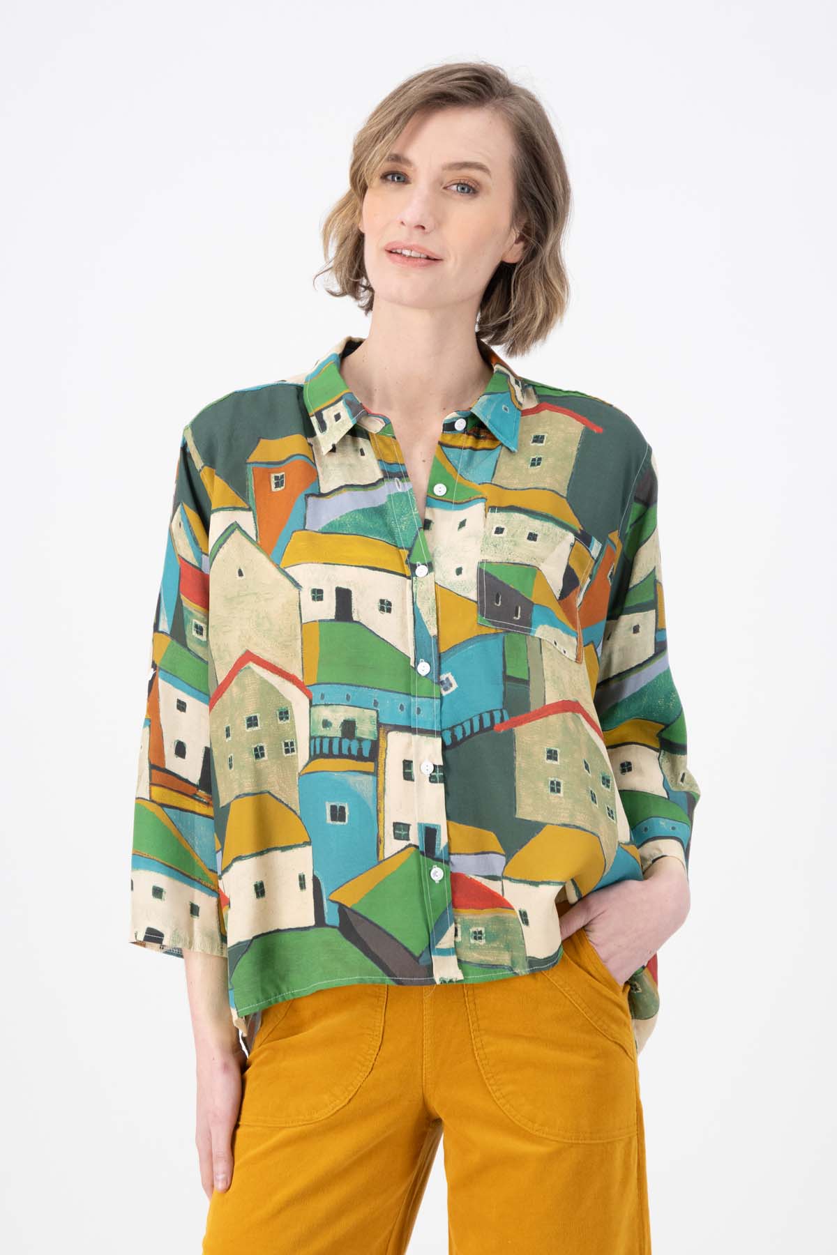 Green Pueblito printed viscose shirt with a button down front and 3/4 sleeves. Finishes at the hip. Front view on model.