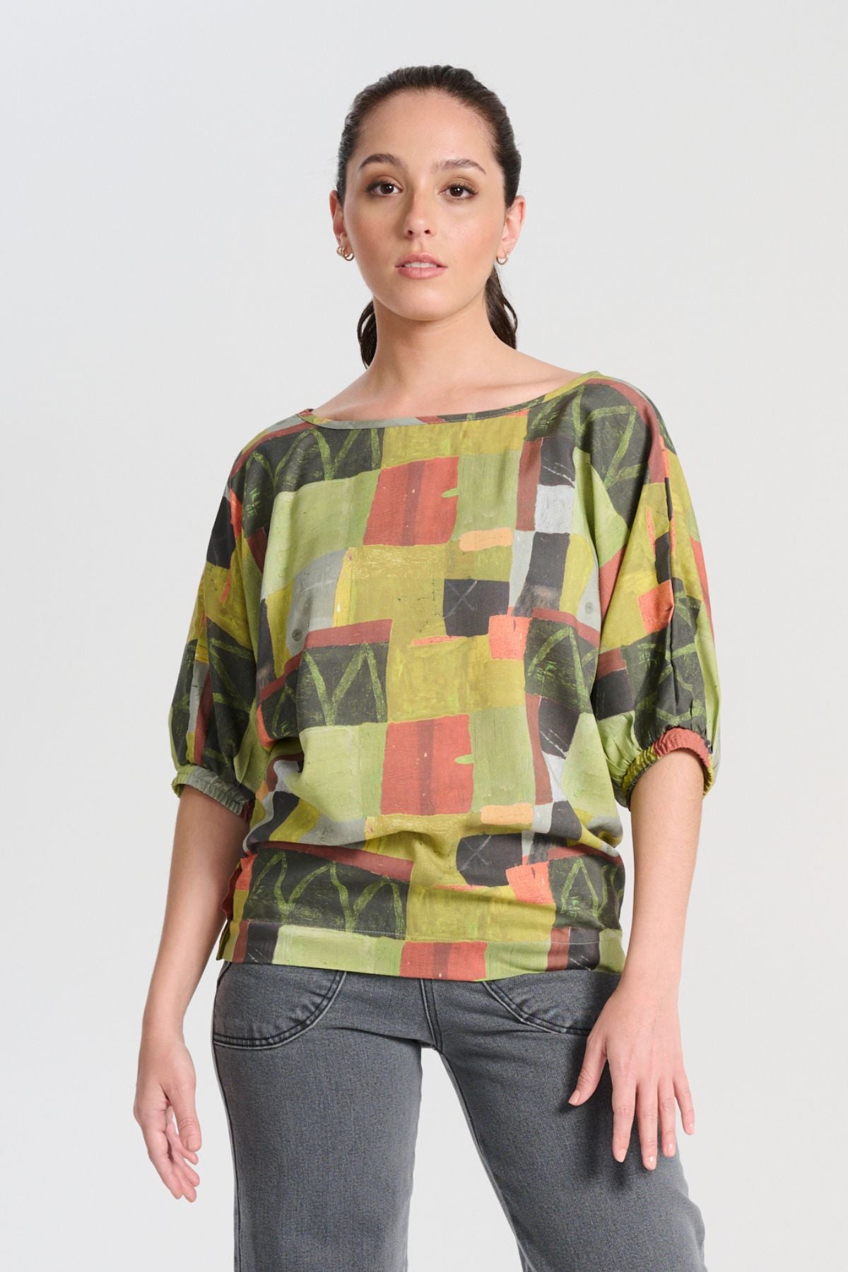 Olga de Polga printed green Kismet Sage Camisa blouse. a bat-winged blouse with short sleeves and is great for everyday wear. Front view on model