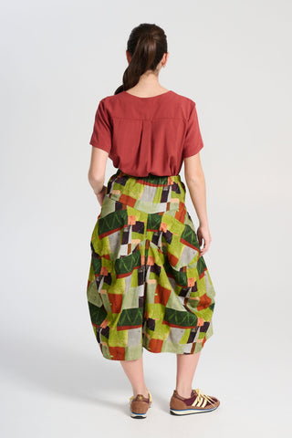 Olga de Polga Sage green Kismet printed Milwaukee skirt in fine cord. Large patch pockets. Unique panelled design. Back elasticated waistband. Back view on model