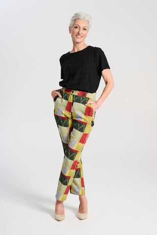 Olga de Polga green printed Pantalon pants in Kismet Sage. The Pantalon is a straight-legged pant that reaches the lower ankle, featuring a button and zip closure at the front with an elasticised back waistband for added comfort. Front full view on model