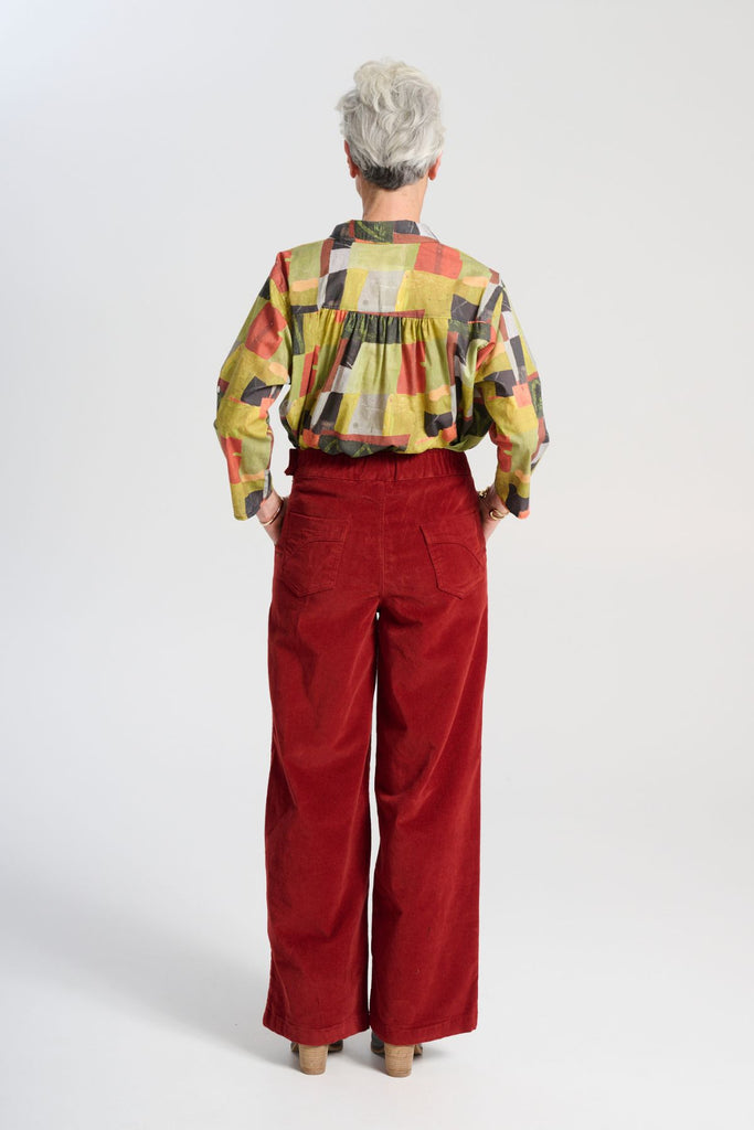 Olga de Polga green classic shirt in the Kismet Sage printed cotton. An effortlessly chic, relaxed silhouette that drapes with ease. Button up front, 3/4 sleeves, collar, dropped shoulders. Longer at back hem. Back view on model