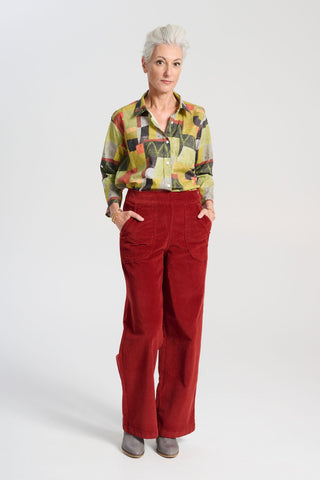 Olga de Polga green classic shirt in the Kismet Sage printed cotton. An effortlessly chic, relaxed silhouette that drapes with ease. Button up front, 3/4 sleeves, collar, dropped shoulders. Longer at back hem. Front full length view on model