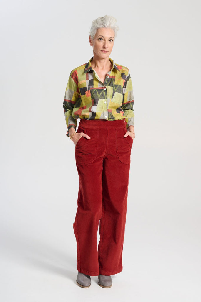 Olga de Polga green classic shirt in the Kismet Sage printed cotton. An effortlessly chic, relaxed silhouette that drapes with ease. Button up front, 3/4 sleeves, collar, dropped shoulders. Longer at back hem. Front full length view on model