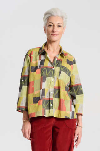 Olga de Polga green classic shirt in the Kismet Sage printed cotton. An effortlessly chic, relaxed silhouette that drapes with ease. Button up front, 3/4 sleeves, collar, dropped shoulders. Longer at back hem. Front view on model.