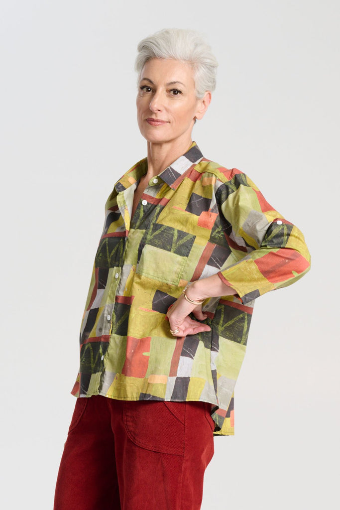 Olga de Polga green classic shirt in the Kismet Sage printed cotton. An effortlessly chic, relaxed silhouette that drapes with ease. Button up front, 3/4 sleeves, collar, dropped shoulders. Longer at back hem. Side view on model