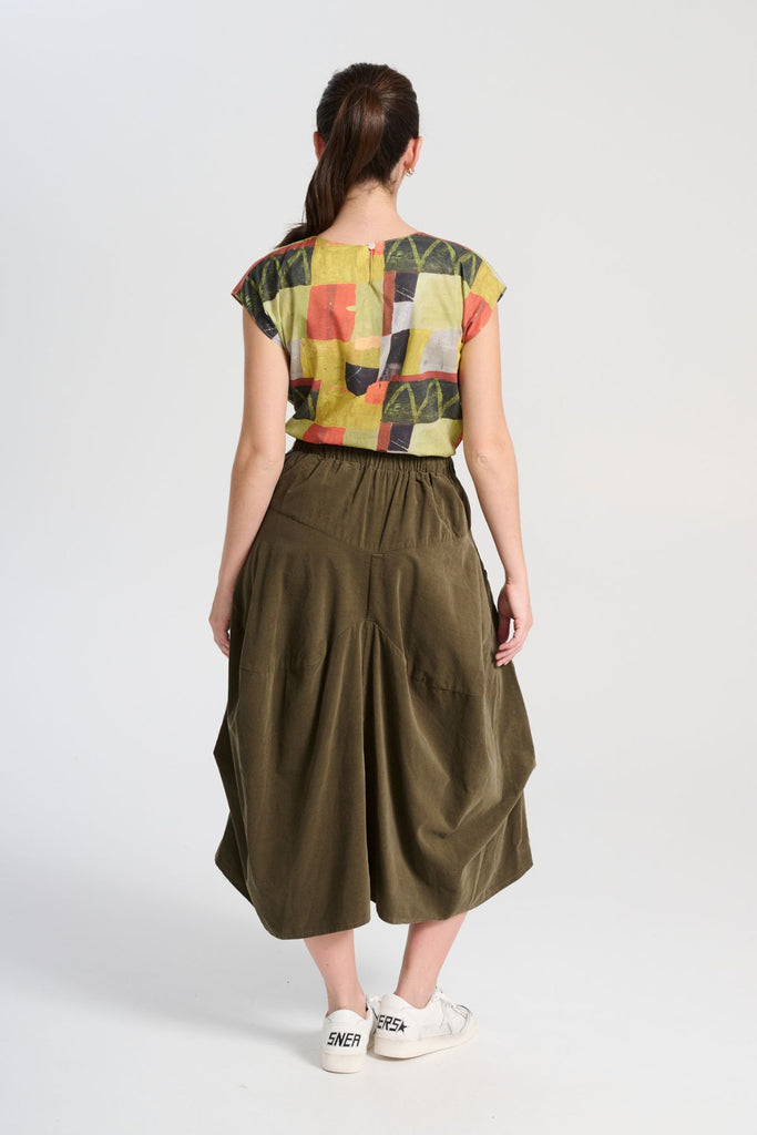 Olga de Polga tee in Sage Kismet printed soft wash cotton. Round neckline, cap sleeves. Tapers in slightly at the waist. Back view on model