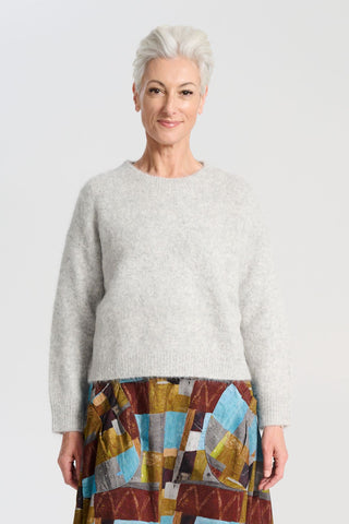 Olga de Polga Aspen sweater in Light Grey. With its soft alpaca blend, and insulating warmth, it’s the perfect staple for layering or wearing on its own. Front view on model
