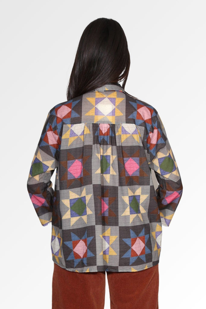 Olga de Polga women's printed cotton voile shirt in grey with accents of mustard, purple, pink, maroon and blue. Bak view on model