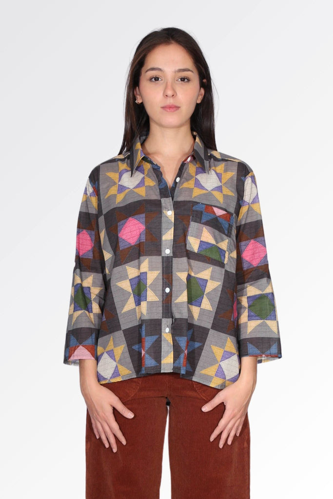 Olga de Polga women's printed cotton voile shirt in grey with accents of mustard, purple, pink, maroon and blue. Front view on model