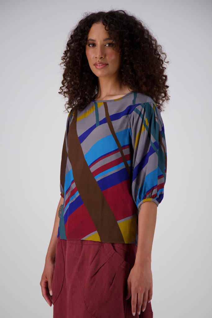 Olga de Polga classic blouse in grey Crossroads Primary printed viscose. Side front on model