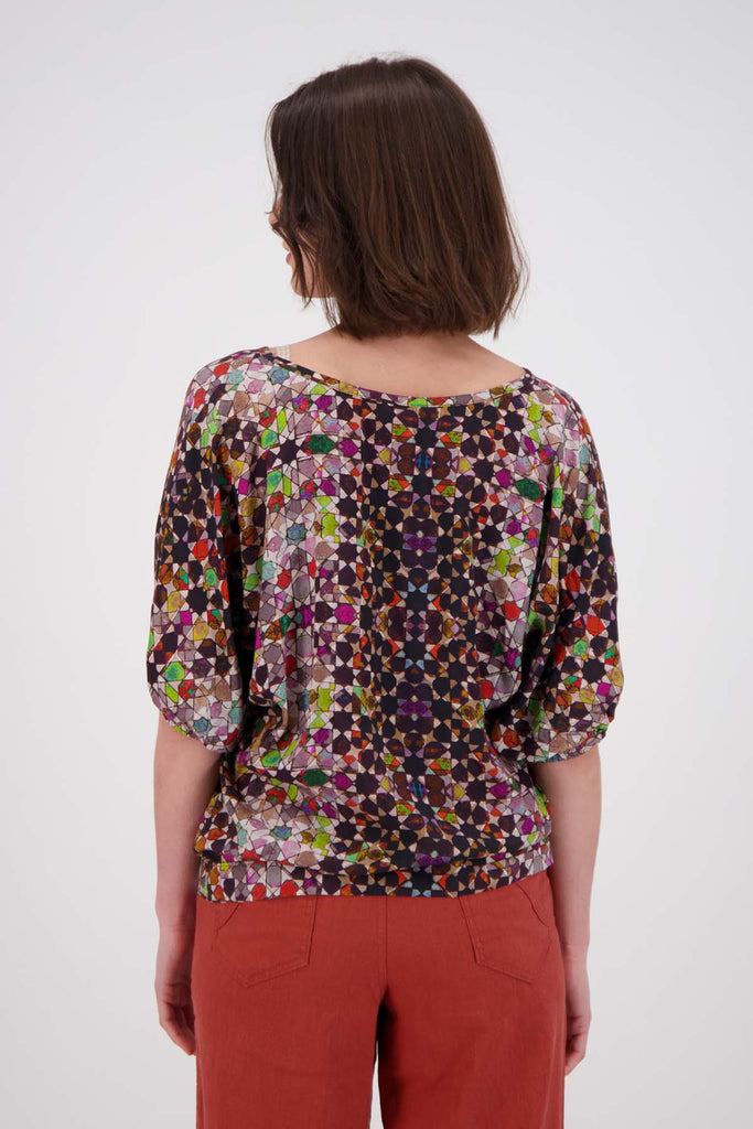 Olga de Polga Grey Kaleidoscope Camisa blouse in fine Tencel fabric. a reversible bat-winged blouse with short sleeves and is great for everyday wear. Back  view on model 