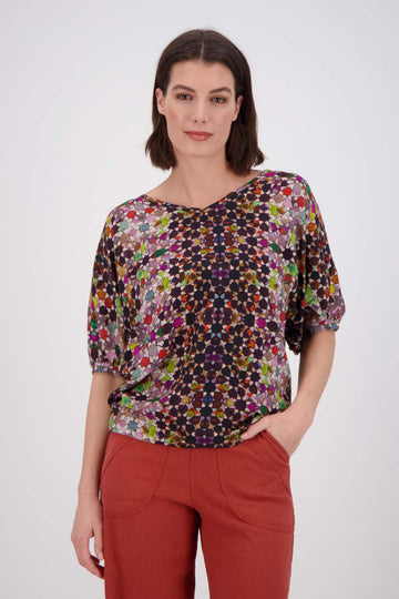 Olga de Polga Grey Kaleidoscope Camisa blouse in fine Tencel fabric. a reversible bat-winged blouse with short sleeves and is great for everyday wear. Front view on model 