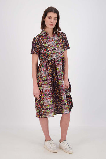 Olga de Polga Grey Kaleidoscope printed Villa dress in long length. Shirt dress with a button front. Finishes just below the knee. 100% Cotton. Front view on model.