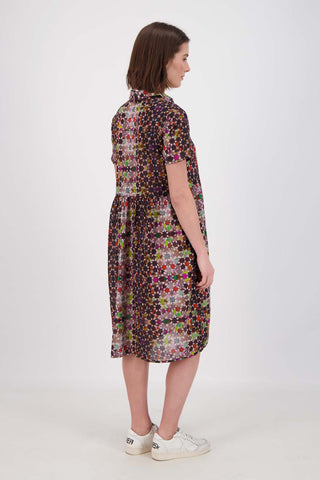 Olga de Polga Grey Kaleidoscope printed Villa dress in long length. Shirt dress with a button front. Finishes just below the knee. 100% Cotton. Side back view on model.