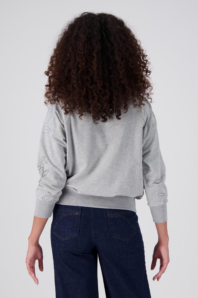 Grey Olga de Polga Montage Sweater in a soft brushed cotton tencel blend. The sweatshirt features abstract embroidered motifs on the front and arms. The sweatshirt has ribbing at the neck, cuffs and hem. This is lightweight and a perfect layering sweater.  Back view