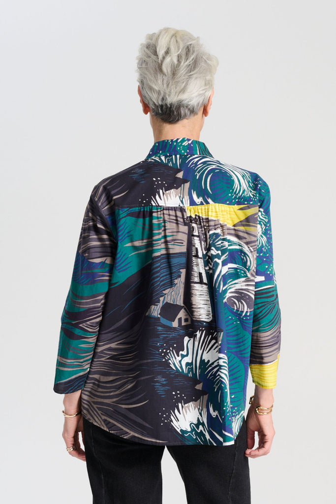 Olga de Polga classic cotton shirt in the Storm grey and blue printed Isla print on 100% cotton. The front of the shirt sits at the waist while the back falls to the hips for a lovely drape.  Back view on model